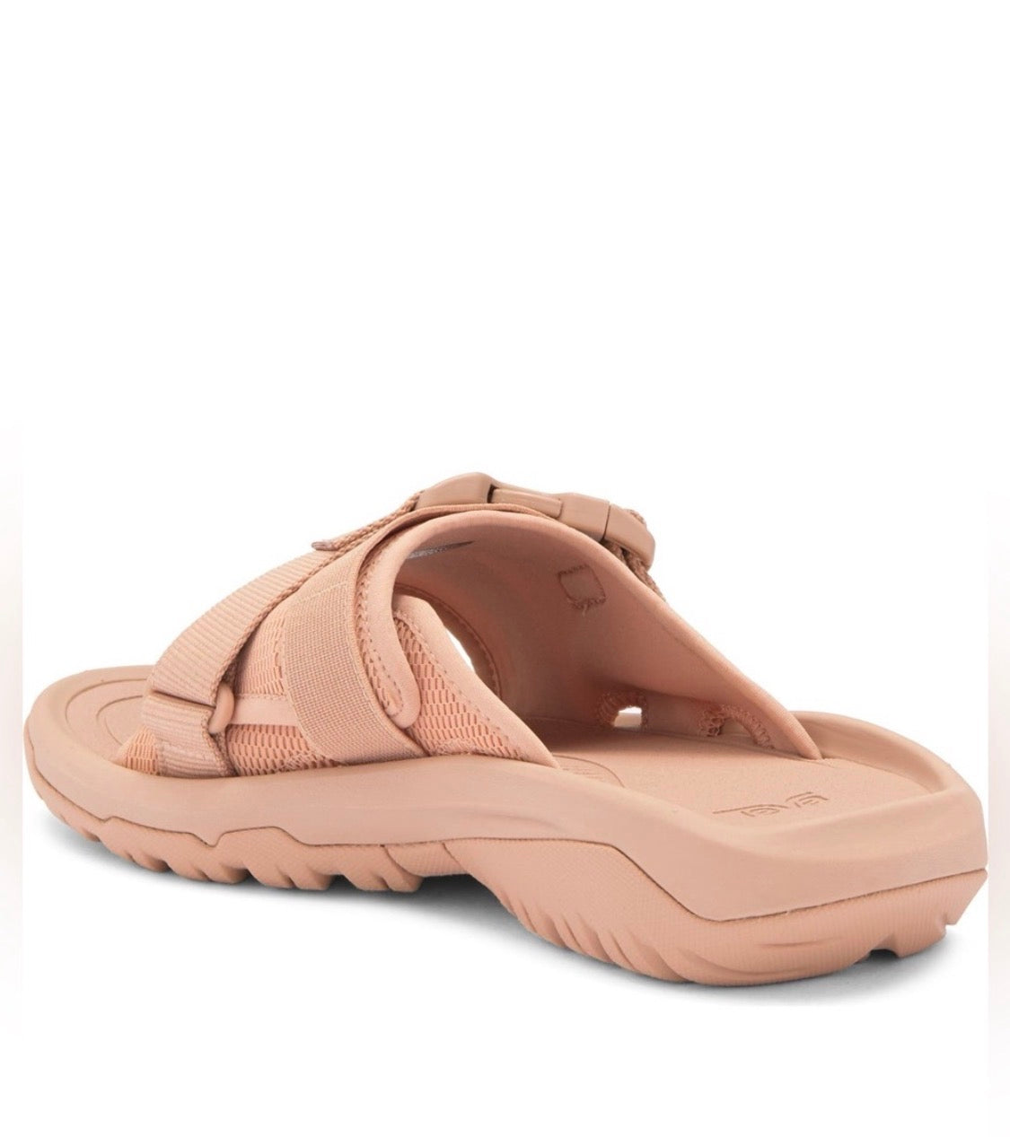 A single slip-on sandal in a dusty peach-pink color, shown from a side profile view against a plain white background.