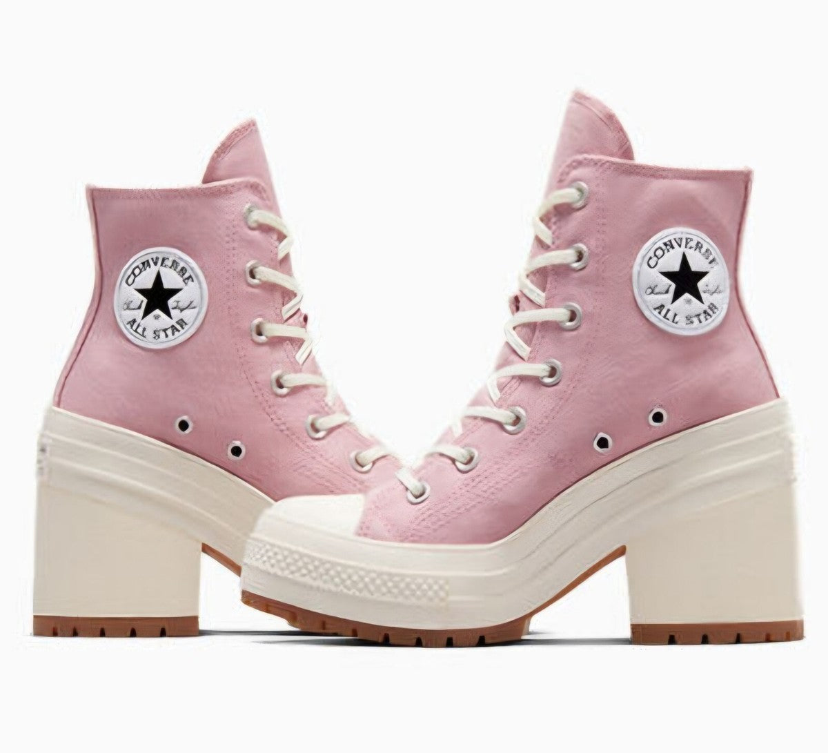 A pair of Converse All Star platform ankle boots in light pink canvas with cream laces, thick cream platform soles, and brown outsole edges, shown against a plain white background.