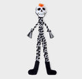 A skeleton-themed dog toy with a white skull head, black braided body, black feet, and a small orange tuft on top, shown against a light gray background.