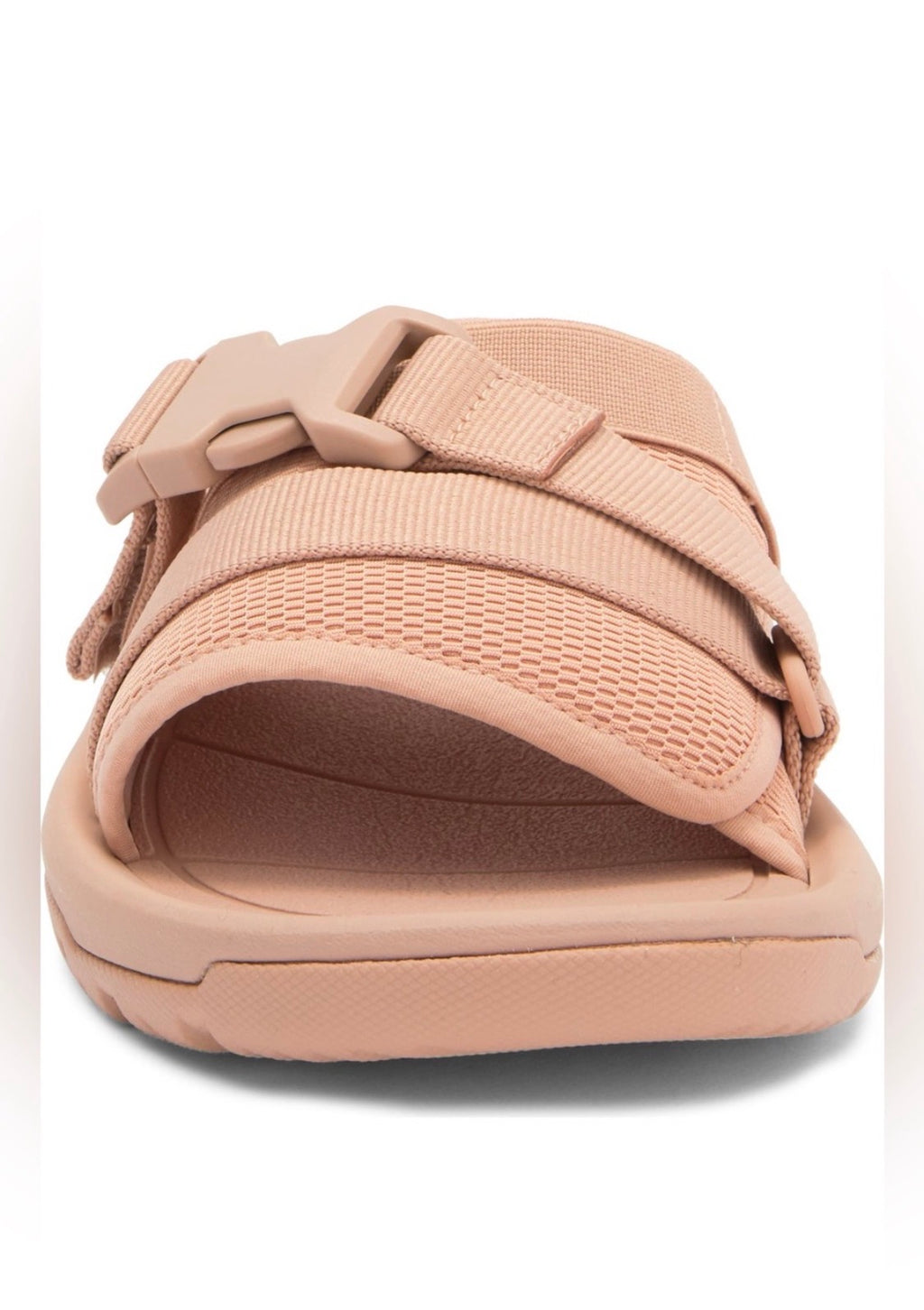 A single slip-on sandal in a dusty rose pink color, featuring a textured mesh upper strap, a padded strap, and a matching molded sole, shown against a plain white background.