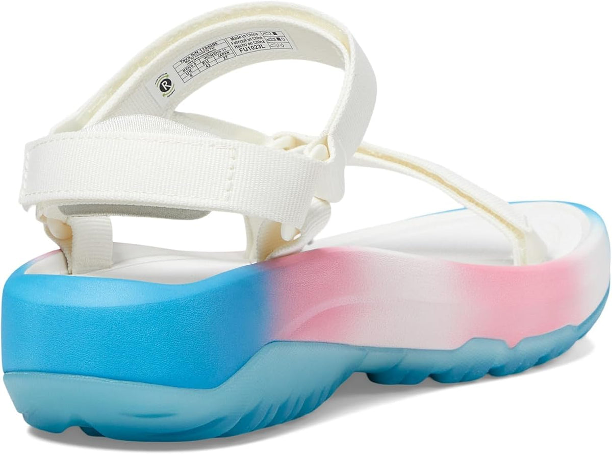 A white platform sandal with a thick sole featuring a blue-to-pink gradient, shown from a side angle on a white background.