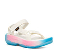 A Teva platform sandal with white straps and a thick sole featuring a pink-to-blue gradient, shown on a plain white background.