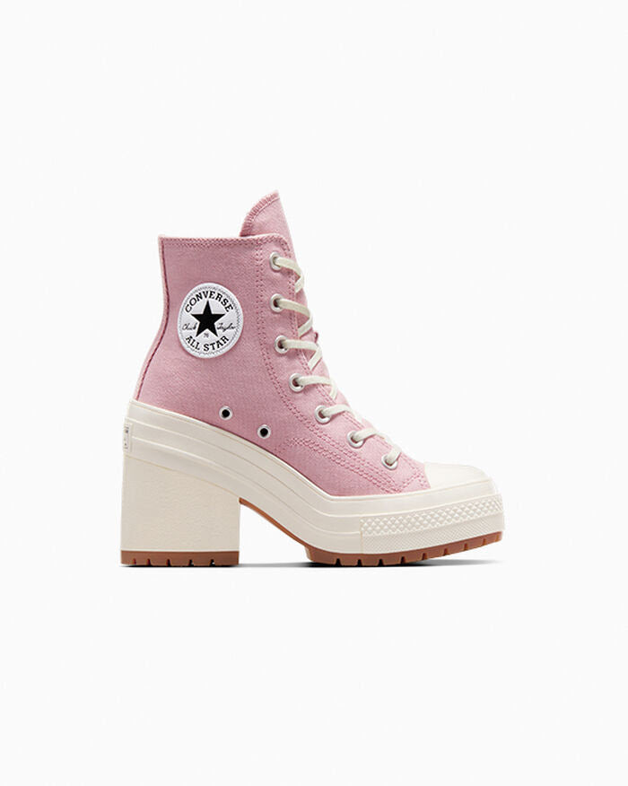 A pink Converse All Star high-top platform sneaker with a chunky cream block heel, cream rubber toe cap, and white laces, shown from a side profile on a light gray background.