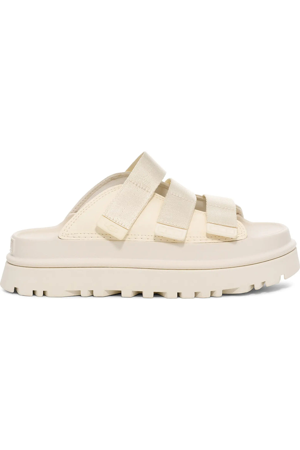 A single cream-colored platform slide sandal with double wide straps, shown from a side profile view against a plain white background.