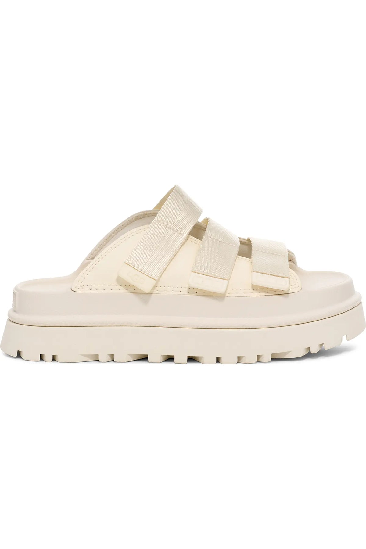 A single cream-colored platform slide sandal with double wide straps, shown from a side profile view against a plain white background.